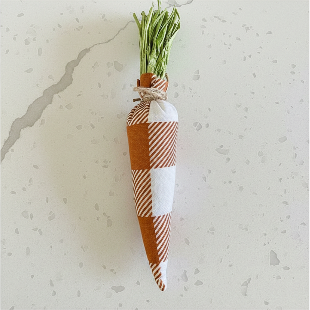 Fabric Carrot with a checkered pattern holding green onions on a light gray background