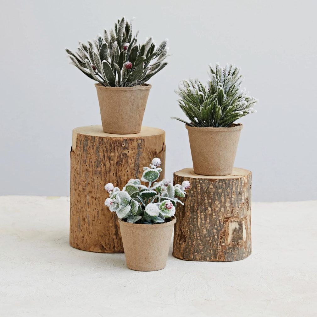 Three paper mache greenery pots with faux wintry greens mix, including crimson red berries and a dusting of snow, displayed on a neutral background.