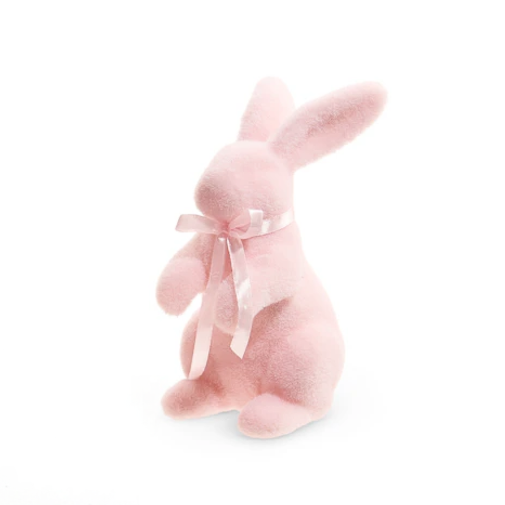 Pink flocked bunny with a bow on a white background