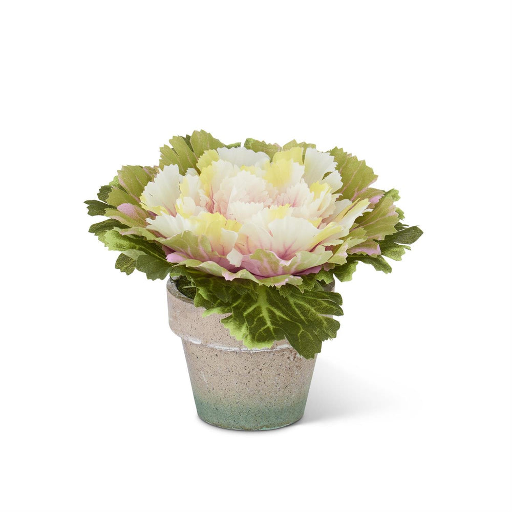 A artificial pink potted cabbage plant with green leaves in a beige pot, designed for home decor.