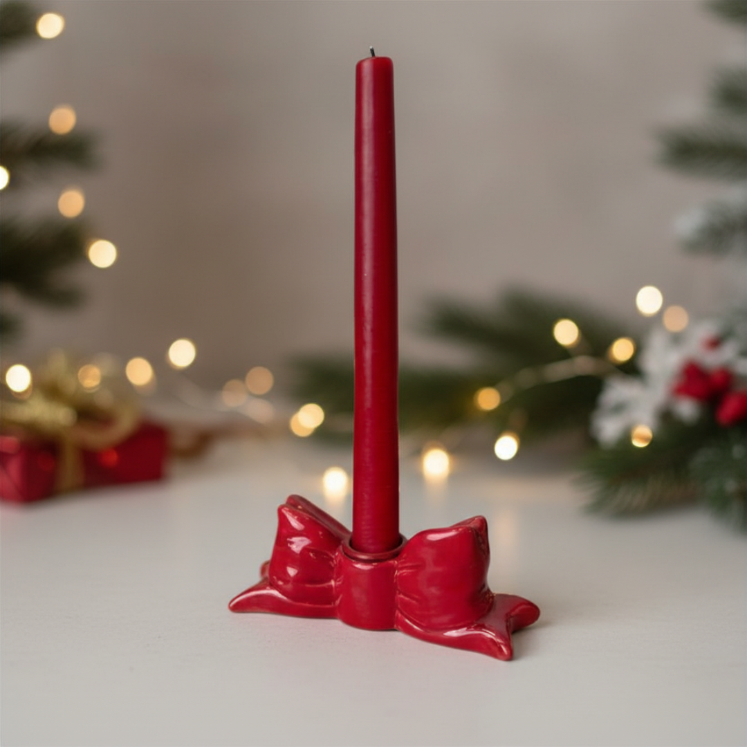 Red candle holder with a red candle on a blurred festive background