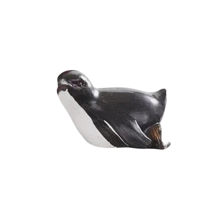 Small figurine of a penguin on a white background