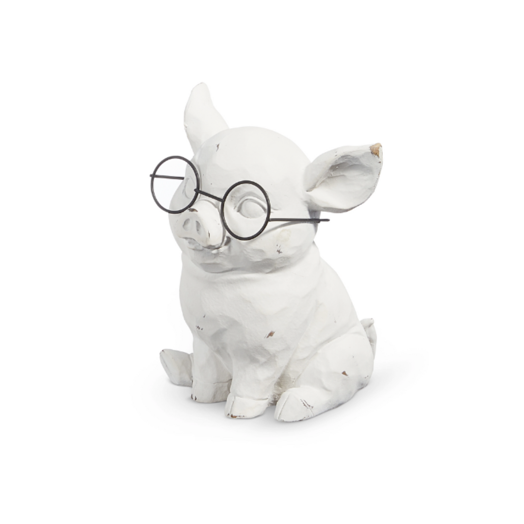 White ceramic pig figurine wearing glasses on a white background