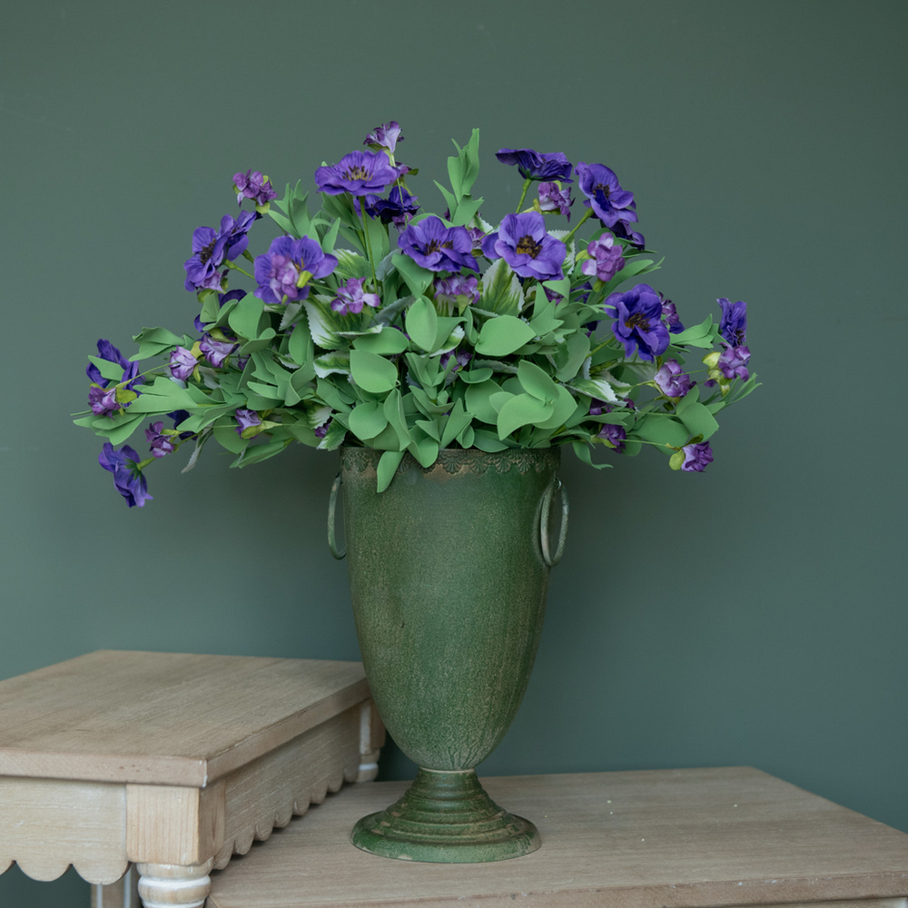 Purple Camellia Wildflower Bush with green foliage in a green vase
