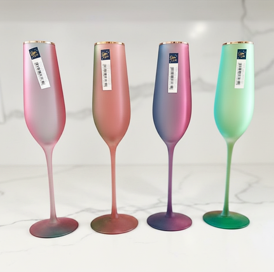 Four multicolored champagne flutes with gradient effects on a white background