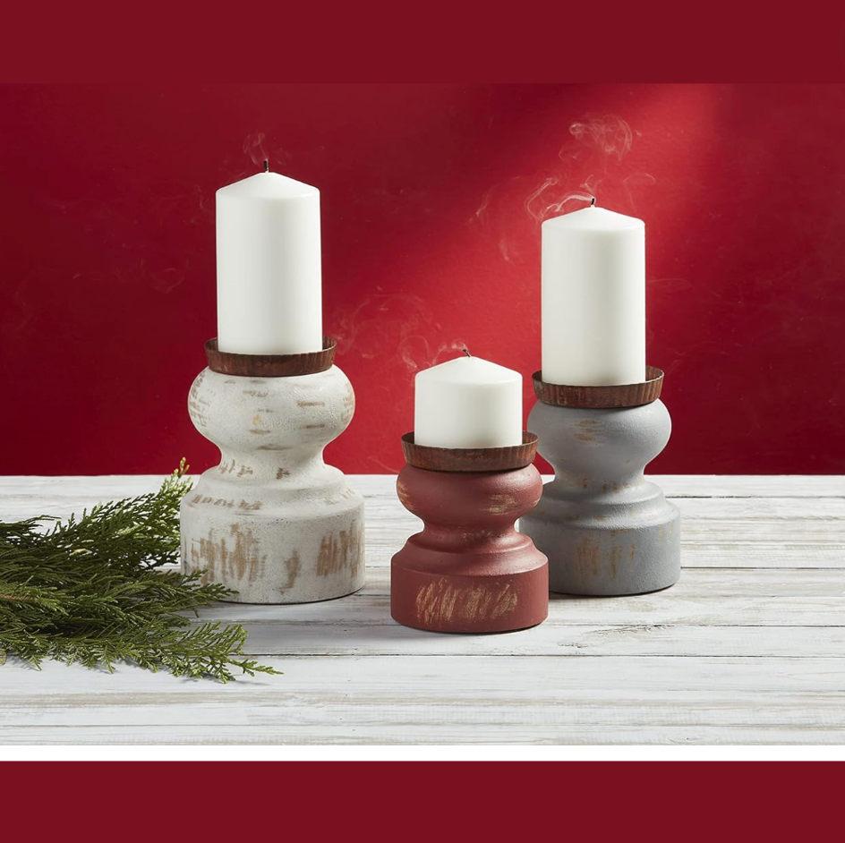 Set of three rustic style candle stands in white, gray, and red colors, made of mango wood, displayed with candles on a white surface with a red background.