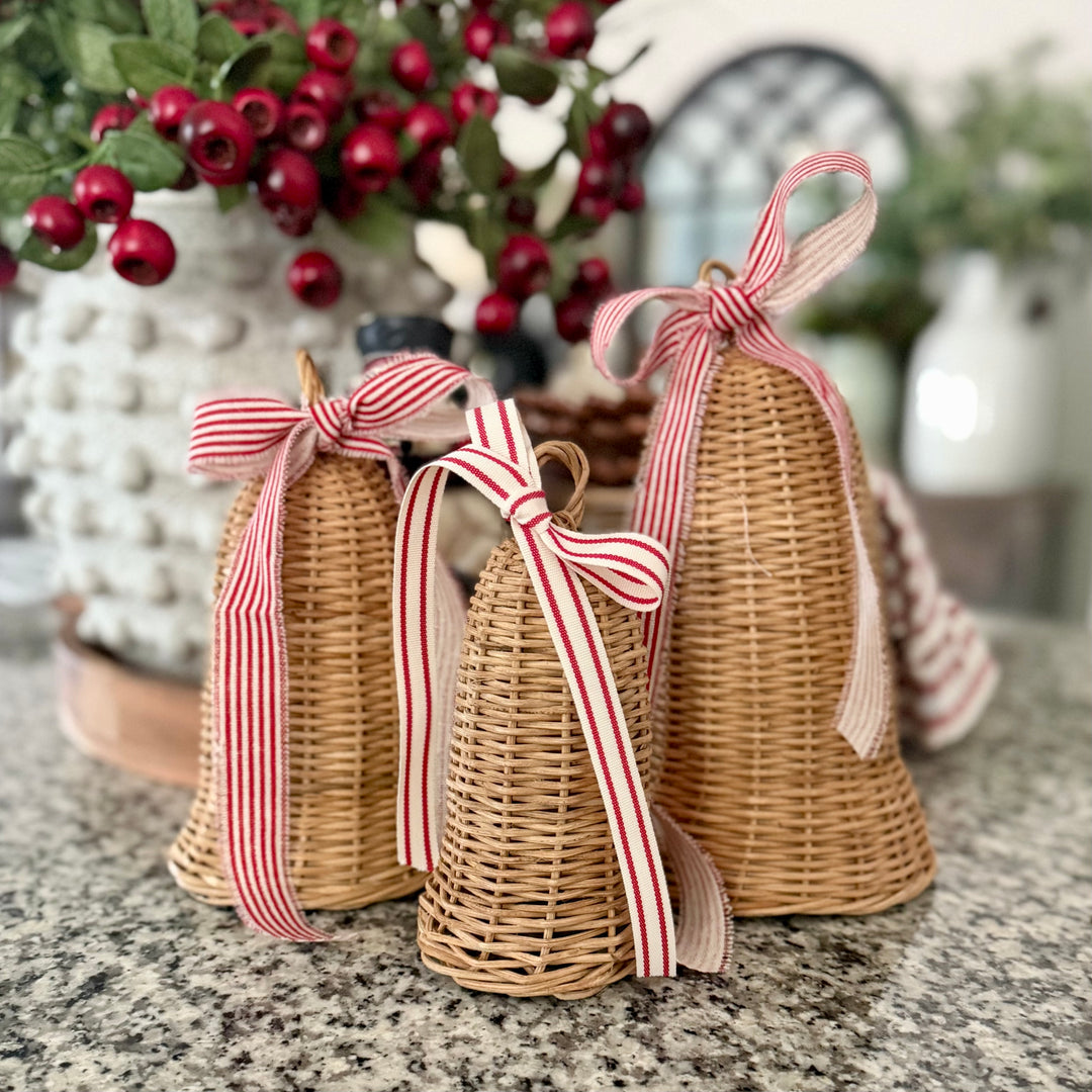 Decorative rattan bells set with  re and white stripe ribbons.