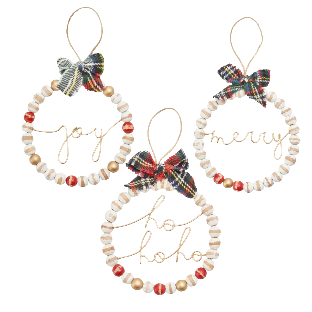 Set of three decorative Christmas ornaments with beads and plaid bows on a white background