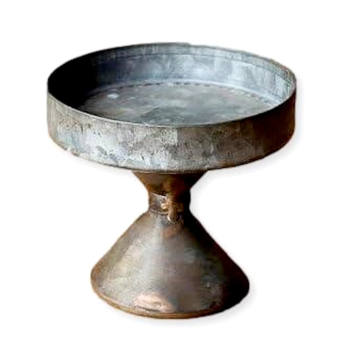 Metallic pedestal dish on a white background