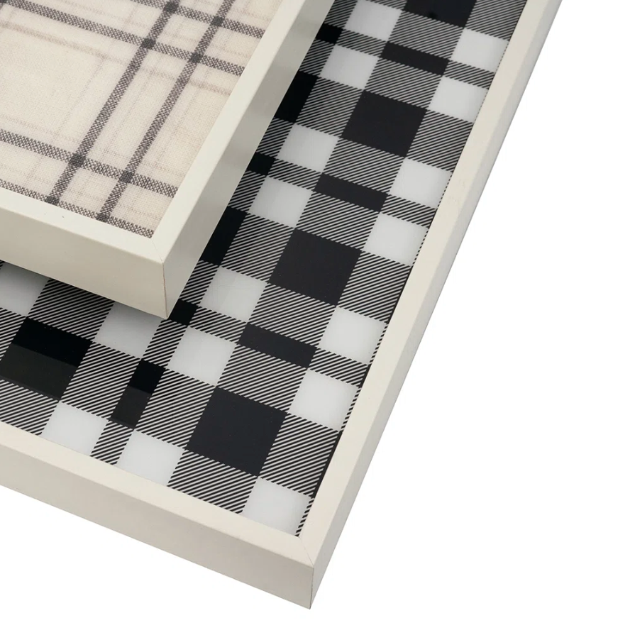 Two white-framed decorative trays stacked diagonally, showcasing a black and white buffalo plaid pattern on a clean white background.
