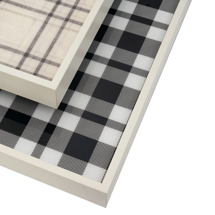 Two white-framed decorative trays stacked diagonally, showcasing a black and white buffalo plaid pattern on a clean white background.