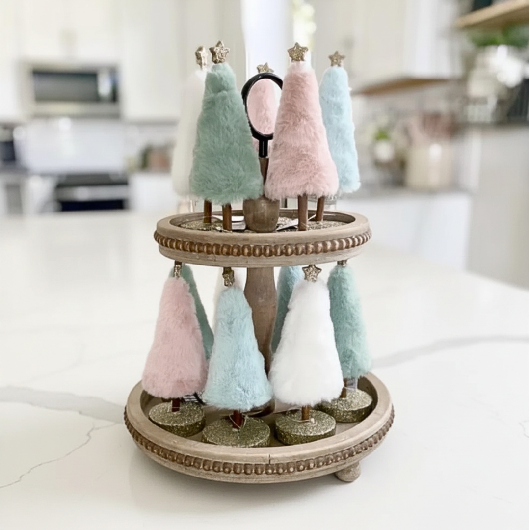 Decorative stand with pastel-colored trees on a white surface