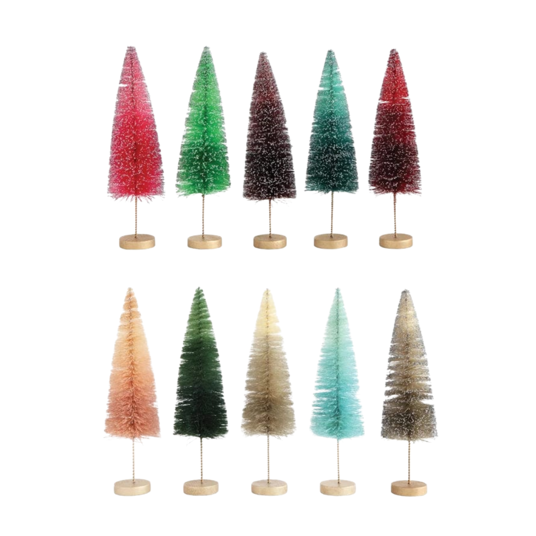 Set of seven colorful Christmas trees on stands against a white background