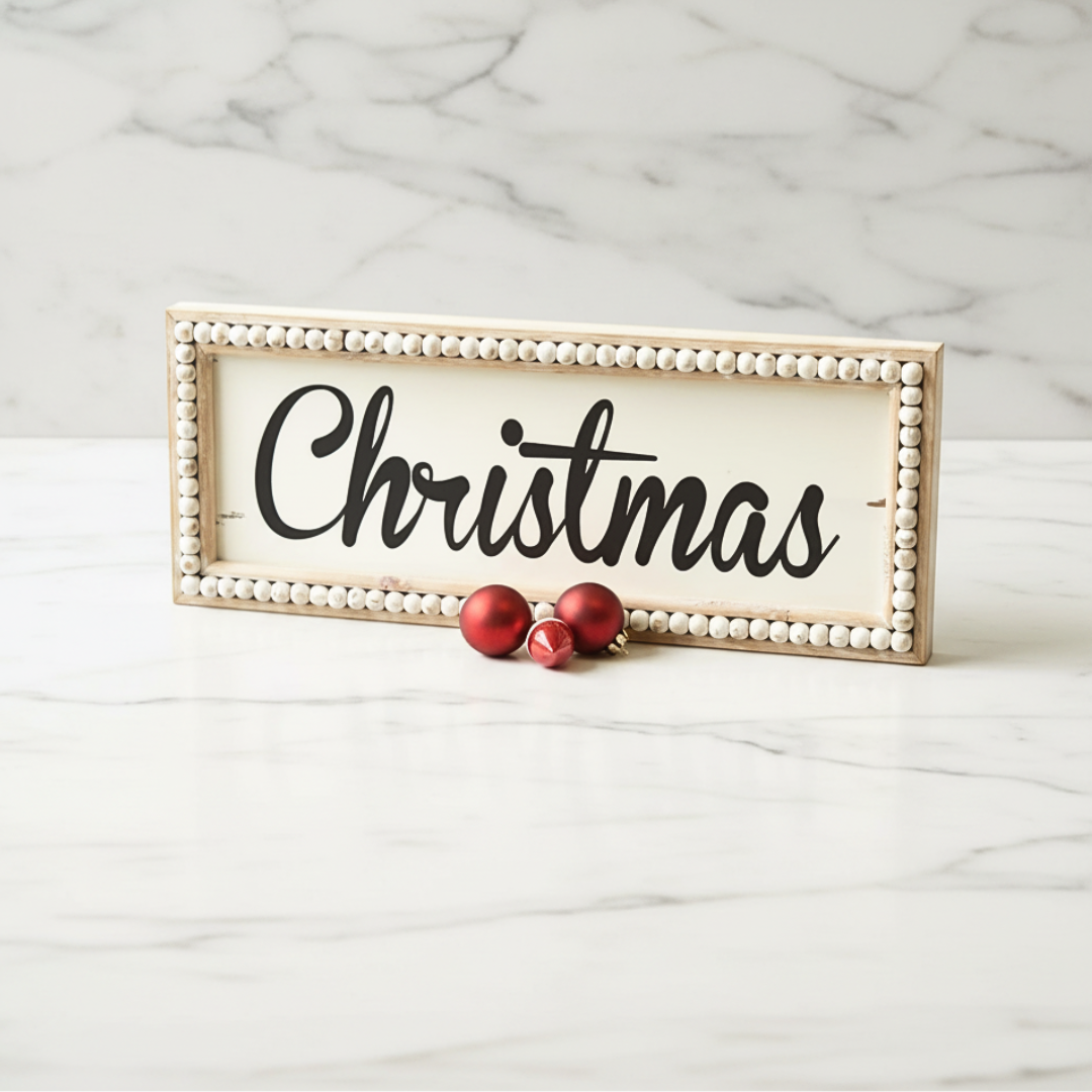 Decorative sign with 'Christmas' text on a marble surface