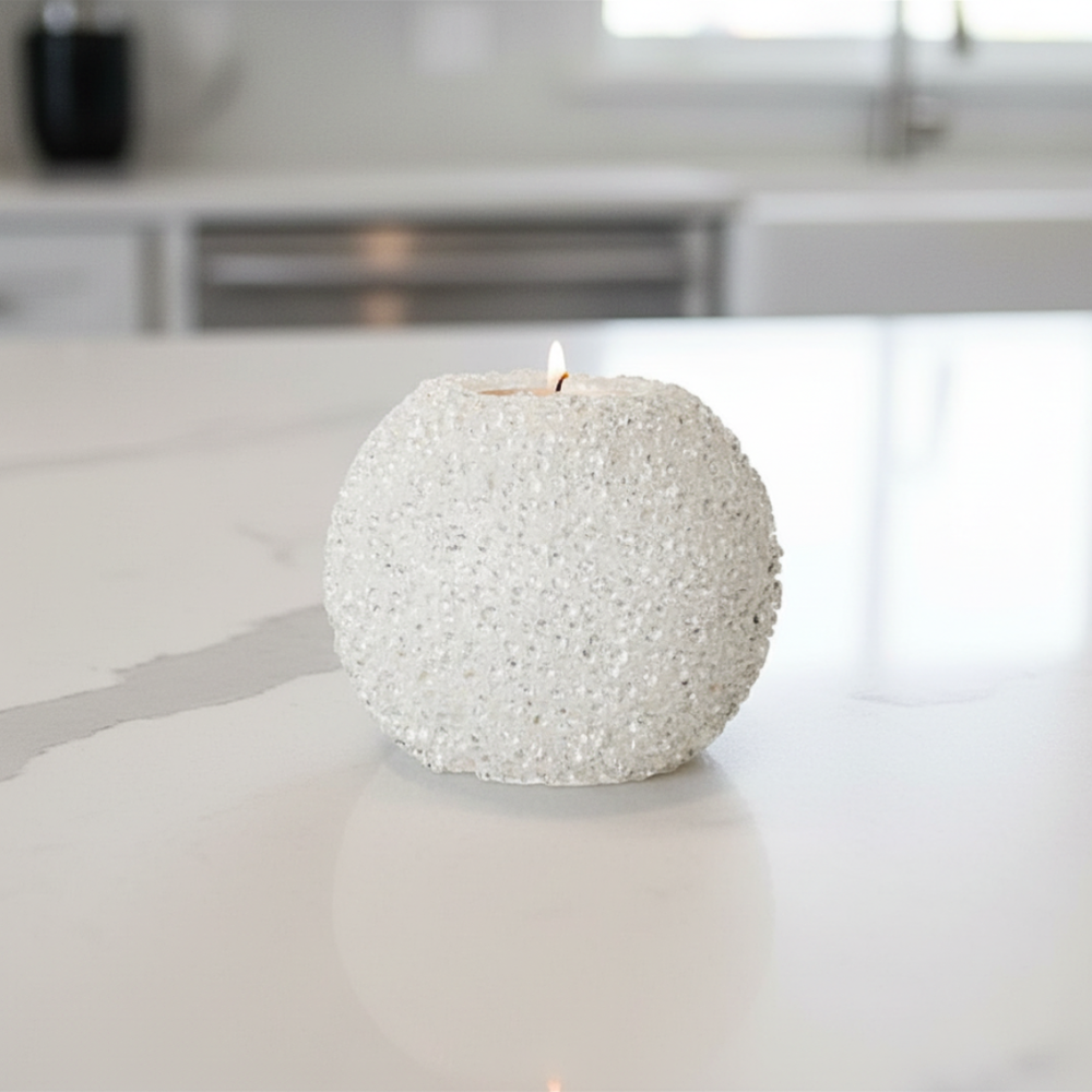White textured candle on a kitchen counter