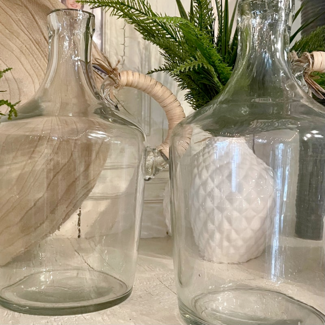 Clear glass decanters on a surface with a blurred background