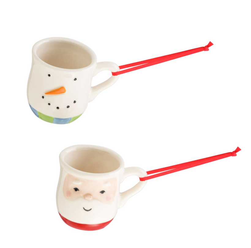 Two ceramic mugs with face designs and red handles on a white background