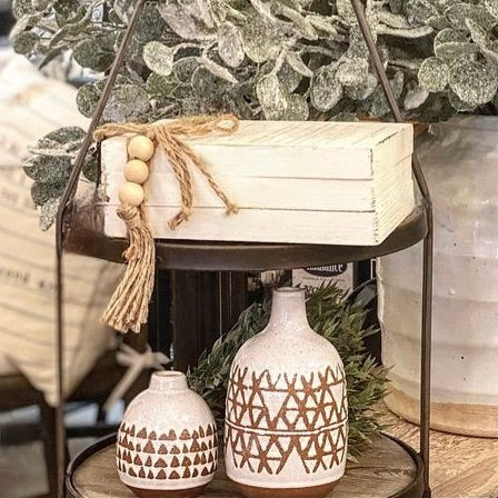Decorative table with patterned vases and plants in a home setting