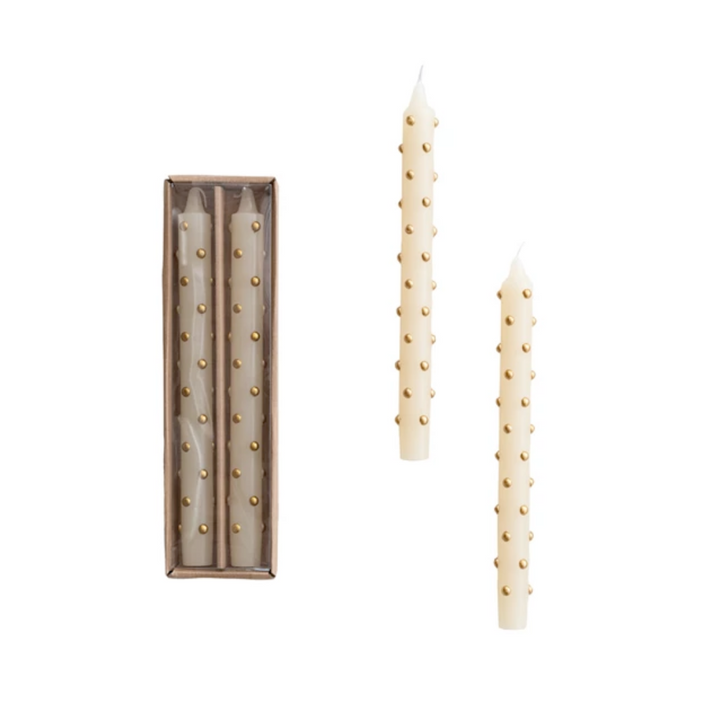 Set of two decorative candles with gold studs on a white background