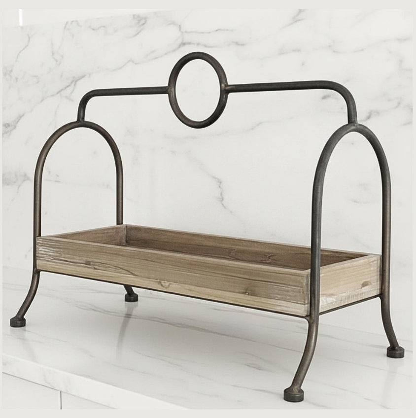 A rustic metal and wood display tray with a dark iron frame featuring a circular top detail and four legs, set against a white marble background.
