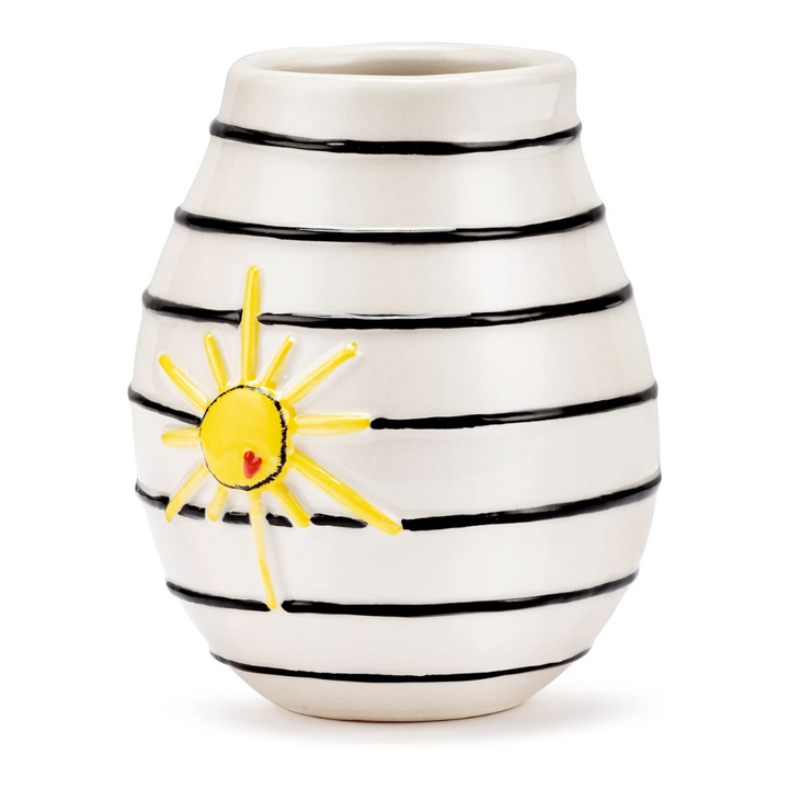 Stoneware vase with black stripes and a yellow sun design on a white background