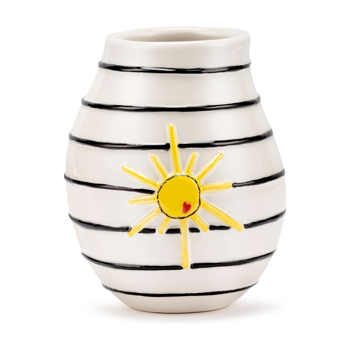 Stoneware vase with black stripes and a yellow sun design on a white background
