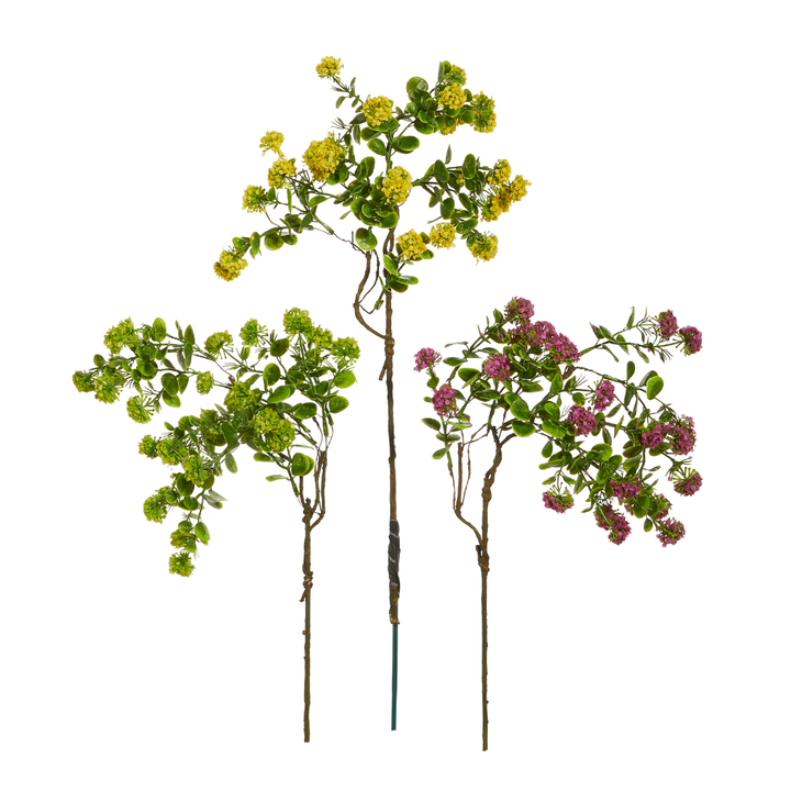 Three artificial flower stems in green, yellow, and pink on a white background