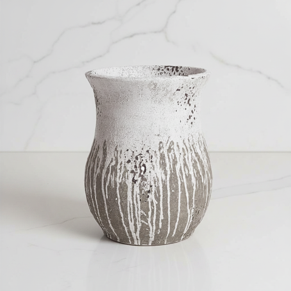 Textured cement vase on a light background