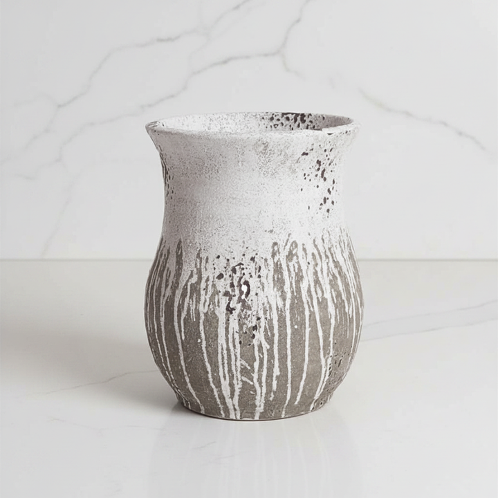 Textured cement vase on a light background