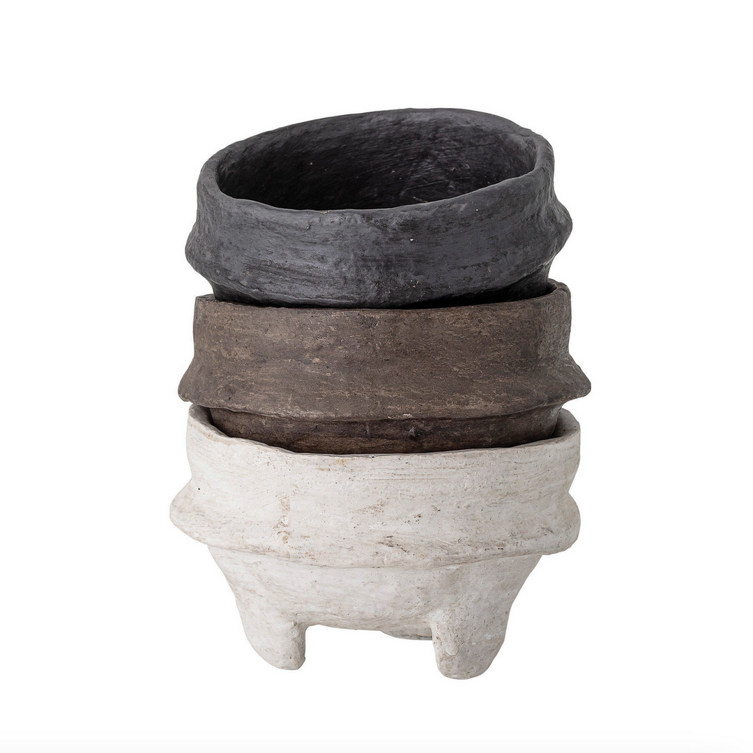 Stack of three paper maché footed bowls with varying textures and colors on a white background