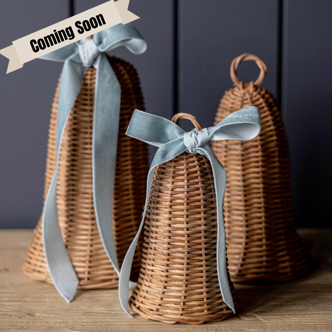 Rattan Bells with ribbons on a wooden surface, with 'Coming Soon' text overlay.