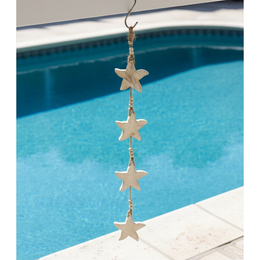 Decorative hanging with starfish shapes in front of a pool