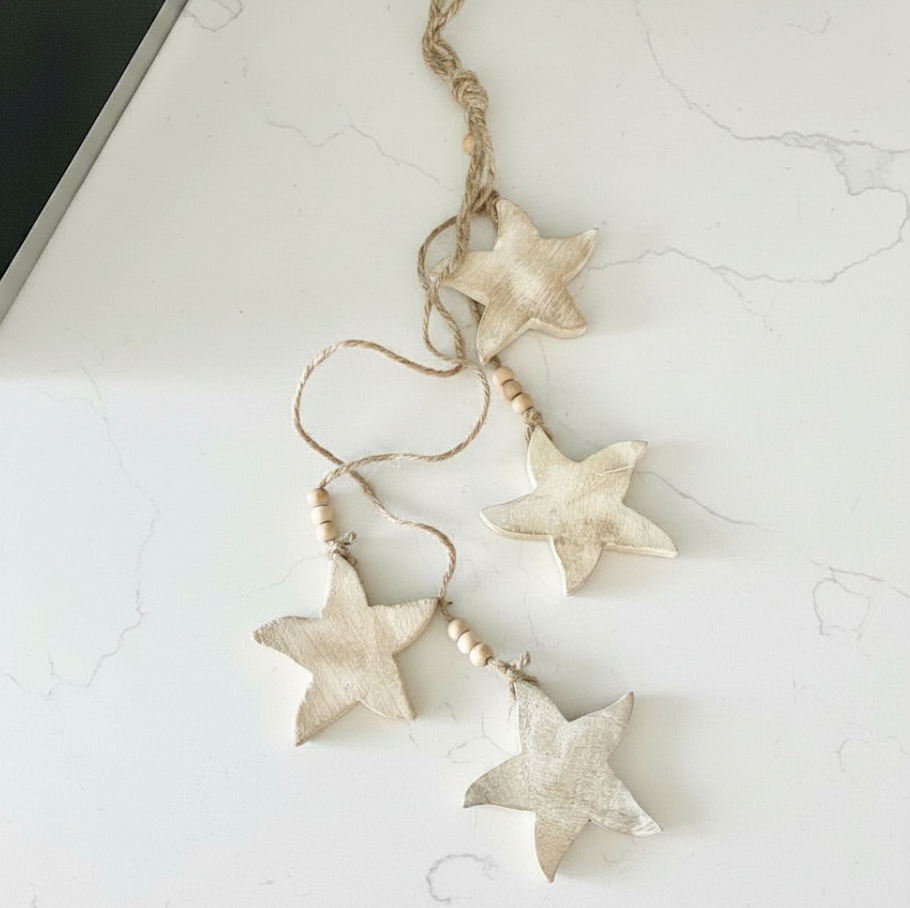 Decorative string with starfish-shaped beads on a light marble surface