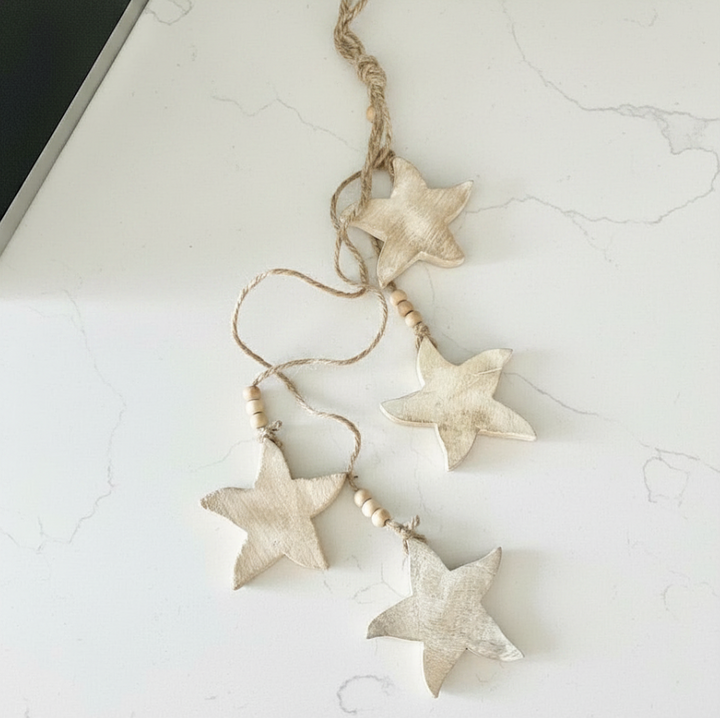 Decorative string with starfish-shaped beads on a light marble surface