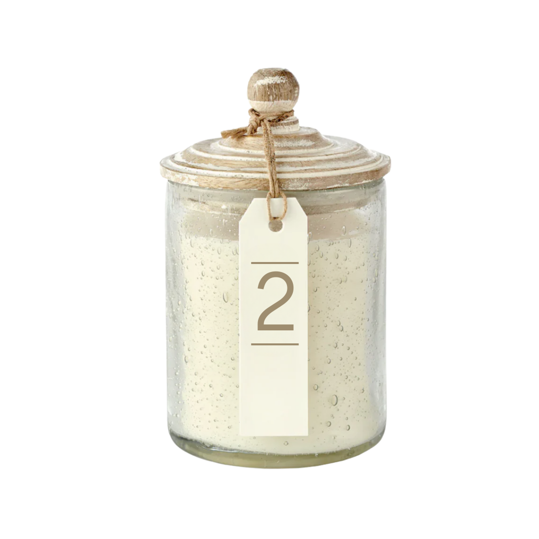 Glass jar with a textured surface and a number '2' tag on a white background