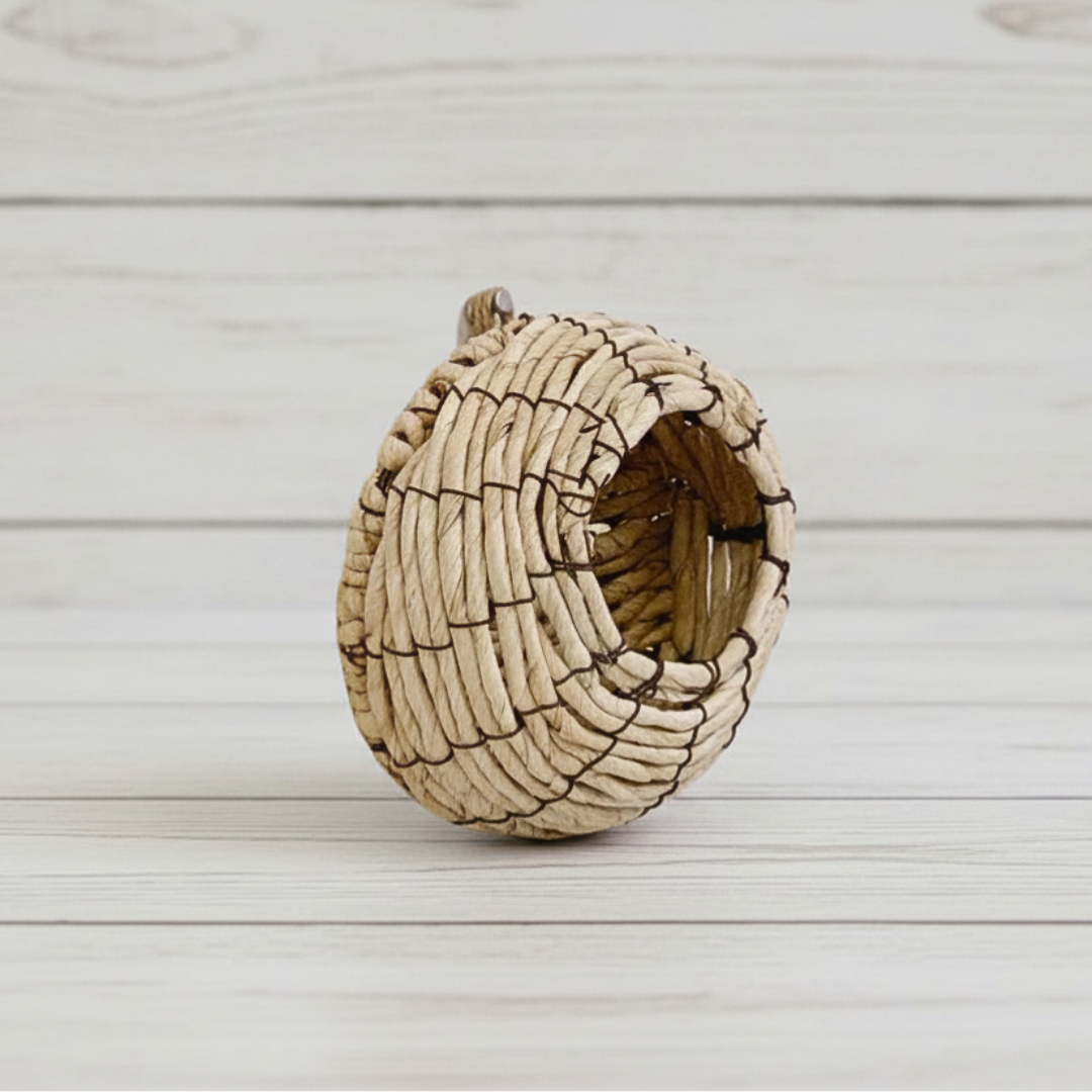 Woven bird nest on a light wooden surface