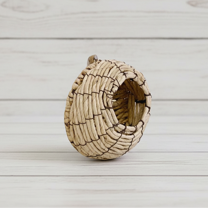 Woven bird nest on a light wooden surface