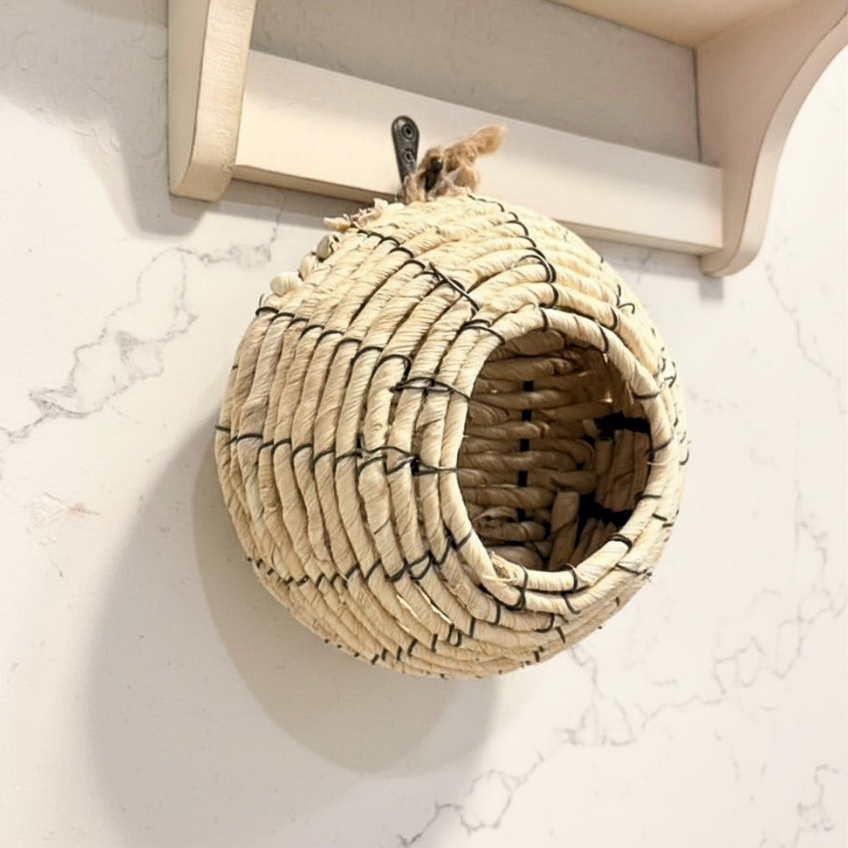 Woven basket with black patterns on a marble surface