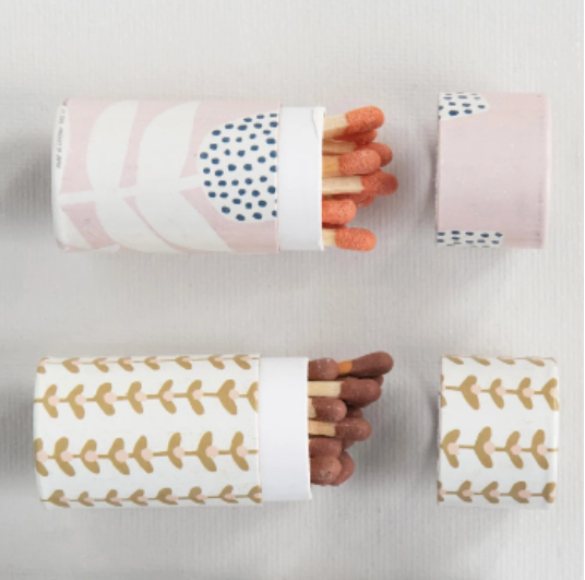 Matches in patterned paper sleeves on a light gray background