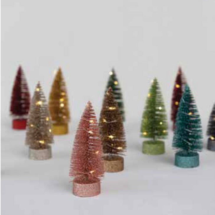 A collection of light-up bottle brush trees in various colors, each with glittery textures and LED lights.